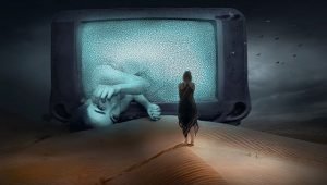 huge screen sitting in a desert showing a sad girl laying on her side and a girl standing in front of the screen watching