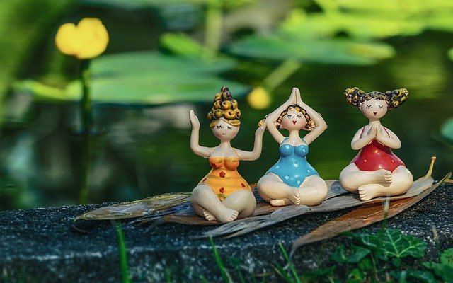 3 ceramic girls sitting in the forest meditating
