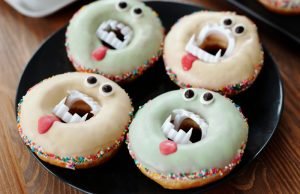4 donuts with vampire teeth in the center